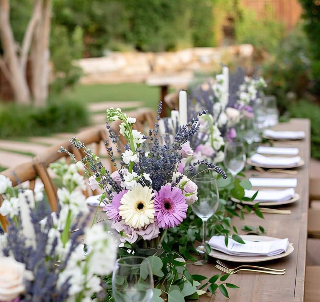 Lavender and purple silk flower centerpiece with white candles for a Melbourne backyard wedding 1 (10) Long table garland featuring purple roses and silk lavender for a rustic garden wedding reception.