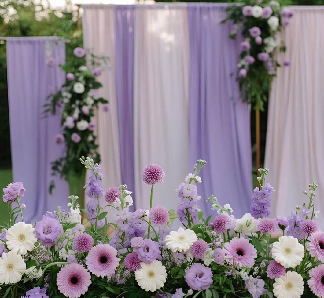 Lavender and purple silk flower centerpiece with white candles for a Melbourne backyard wedding 1 (6) Purple and white silk floral backdrop with lilac drapes for an outdoor wedding ceremony in Mernda.