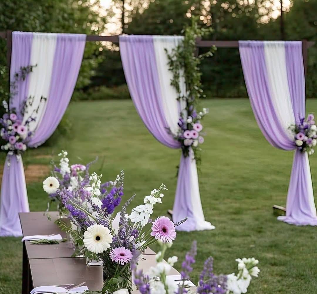 Lavender and purple silk flower centerpiece with white candles for a Melbourne backyard wedding 1 (8) Purple and white silk floral backdrop with lilac drapes for an outdoor wedding ceremony in Mernda.