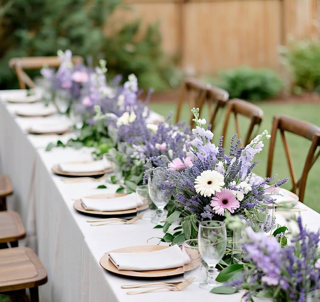 Lavender and purple silk flower centerpiece with white candles for a Melbourne backyard wedding 1 (9) Purple and white silk floral backdrop with lilac drapes for an outdoor wedding ceremony in Mernda.