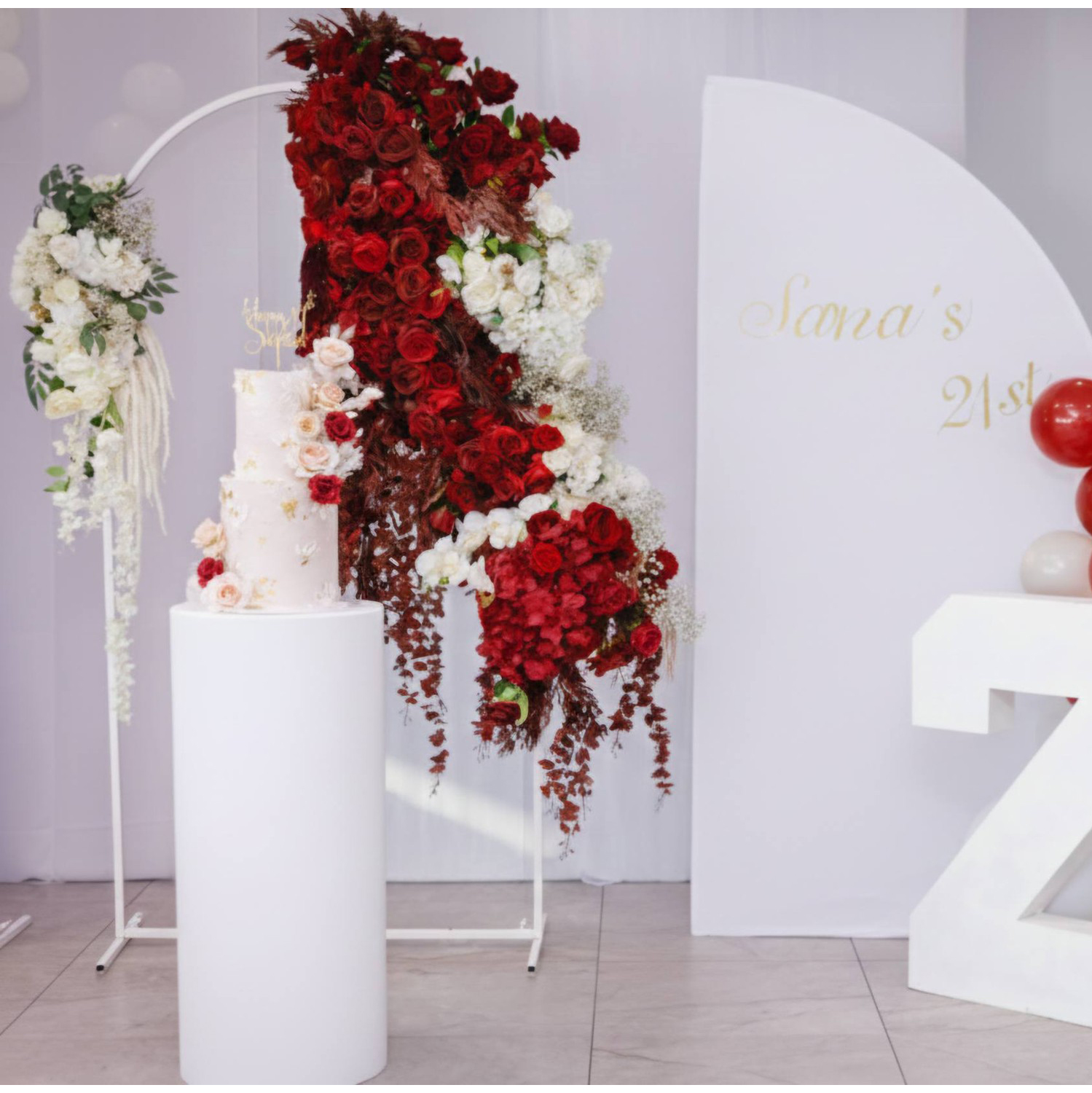 Birthday Backdrop flower decor 2026 1 (20) birthday event decor in Melbourne featuring a red rose hybrid floral arch with white foam letters and balloons by Studio Forever Bloom.