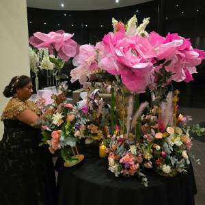 Large pink handmade "Big Bloom" floral arrangement on a black table for a Melbourne event by Studio Forever Bloom.
