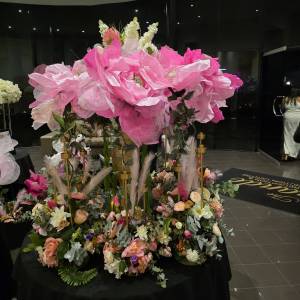 Large pink handmade "Big Bloom" floral arrangement on a black table for a Melbourne event by Studio Forever Bloom.