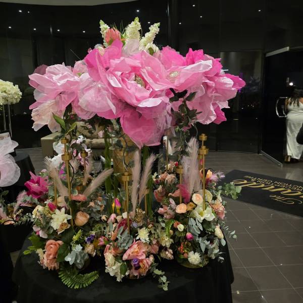 Large pink handmade "Big Bloom" floral arrangement on a black table for a Melbourne event by Studio Forever Bloom.