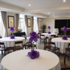 Close up of a giant purple handcrafted silk flower centerpiece with tiered design and ivy.