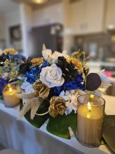 Event Floral Styling Melbourne Studio Forever Bloom Mernda holding a gold and blue silk floral bouquet with matching pillars.