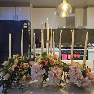 Floral Table Centerpieces Close-up of premium silk pink and peach roses with eucalyptus leaves for event decor.