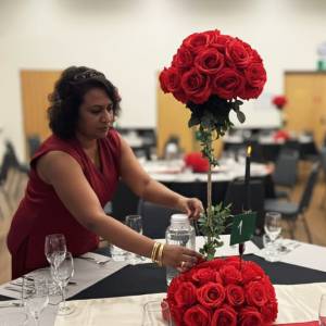 Luxurious red silk floral centerpieces with gold stands and candle holders for a Melbourne wedding by Studio Forever Bloom.