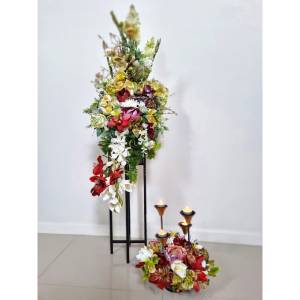 Artificial Flower Arrangements Cascading silk flower arrangement on a black pedestal with a matching ground floral piece and three lit candles for an event in Melbourne.