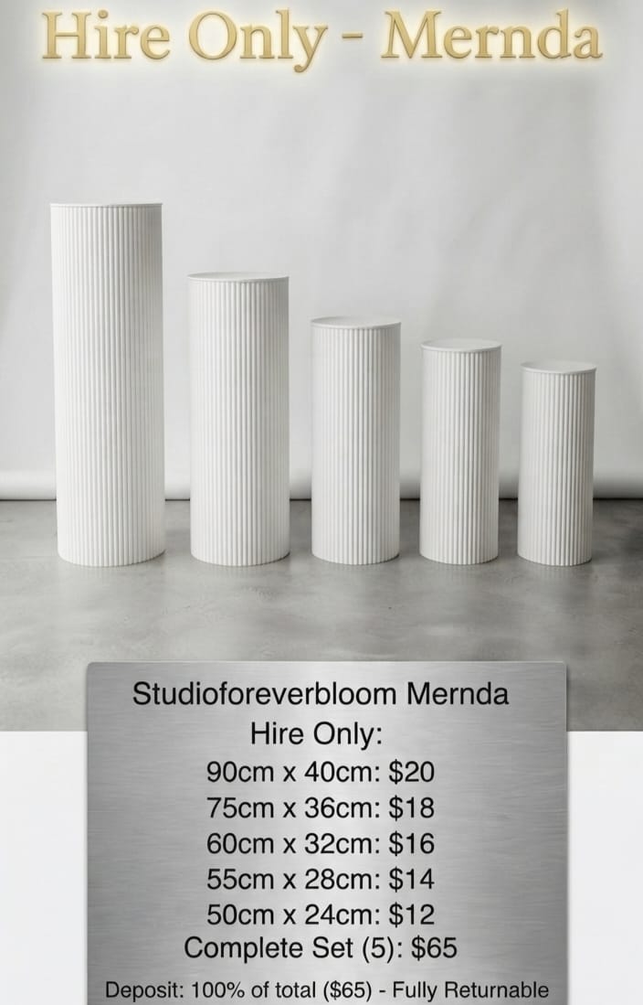 Set of five white fluted cylinder plinths in different heights for wedding and event hire in Melbourne.